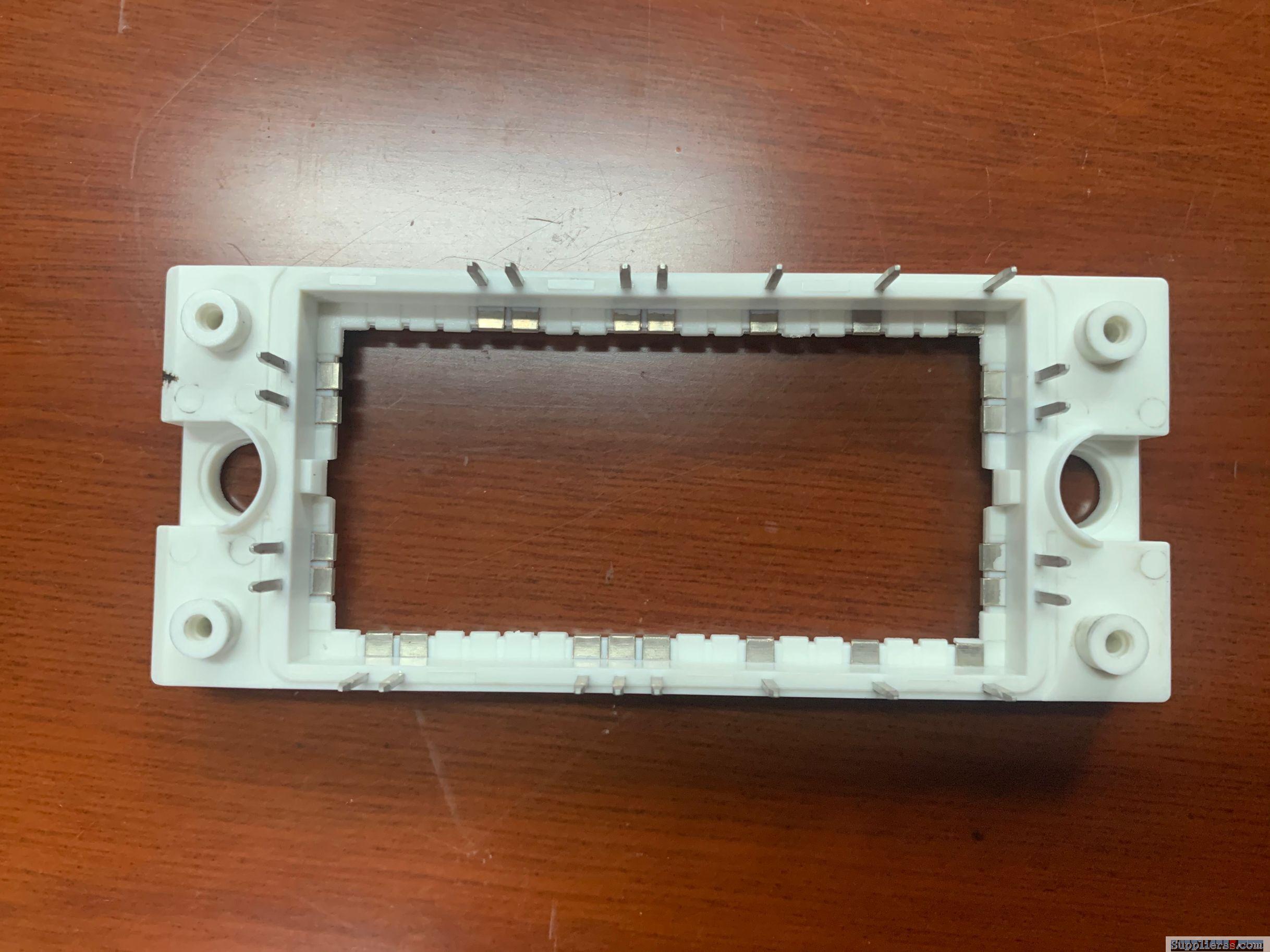Plastic injection frame with metal inserts
